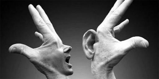 Surreal or abtract composite Image of hands containing mouth and ears communicating. Indicates tensions in communications to illlustrate conflict.