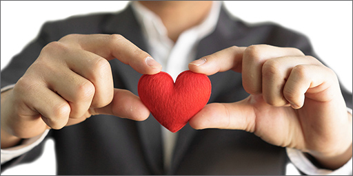Image of hands holding heart-shaped fabric.