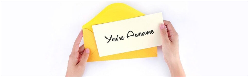 Image of hands holding a note that says 'You're Awesome'.