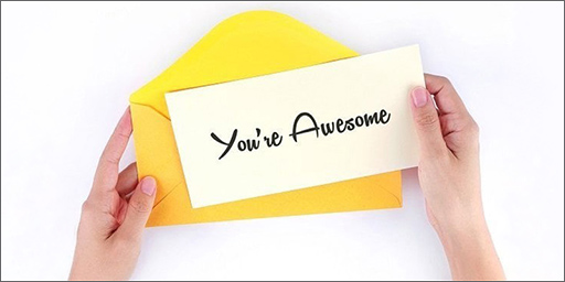 Image of hands holding a note that says 'You're Awesome'.