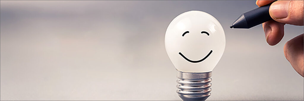 Image of lightbulb with happy face on it.